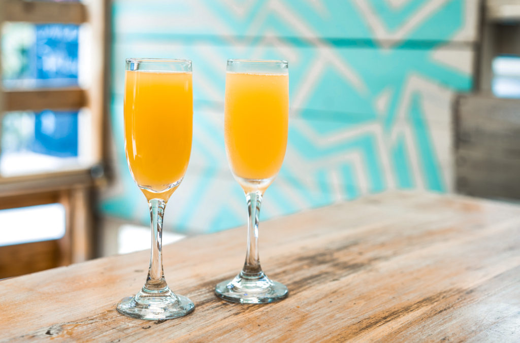 Two glasses of Mimosa on a wooden table. This is one of the most famous French alcoholic beverages.